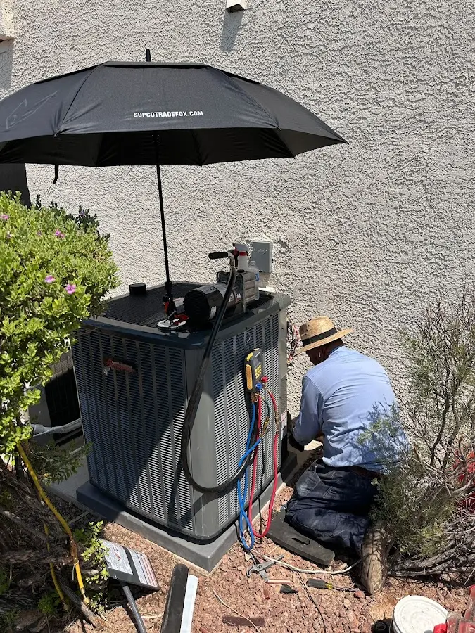 HVAC technician performing outdoor AC maintenance in Broadlands